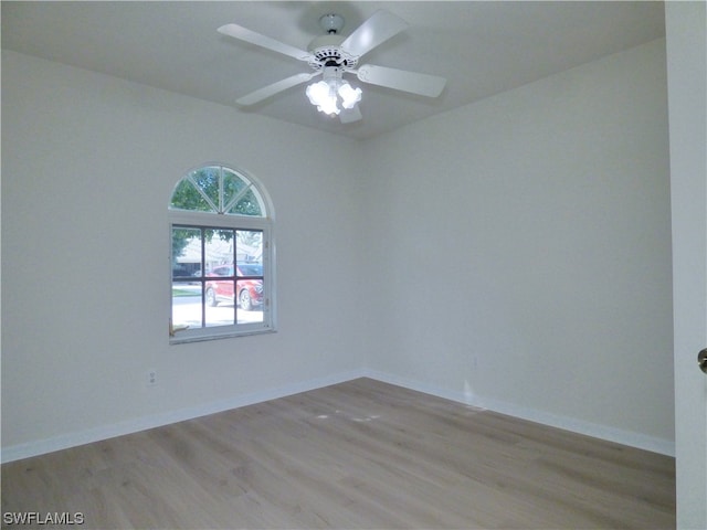 spare room featuring ceiling fan and light hardwood / wood-style flooring