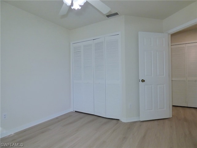 unfurnished bedroom with ceiling fan, a closet, and light hardwood / wood-style flooring