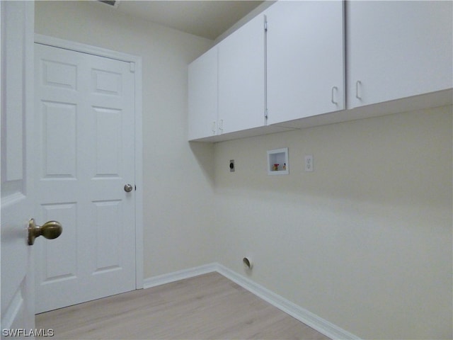 laundry area with light hardwood / wood-style flooring, washer hookup, cabinets, and hookup for an electric dryer