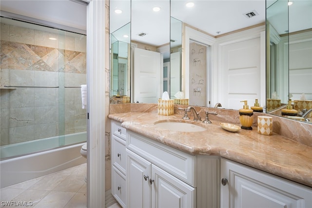 full bathroom with toilet, combined bath / shower with glass door, large vanity, and tile flooring