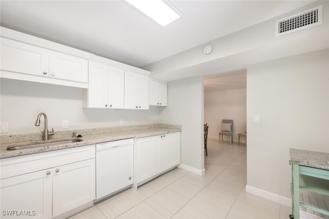 kitchen featuring white cabinets, visible vents, white dishwasher, and a sink