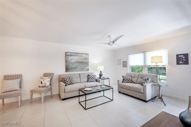 living area featuring light tile patterned floors, baseboards, and a ceiling fan