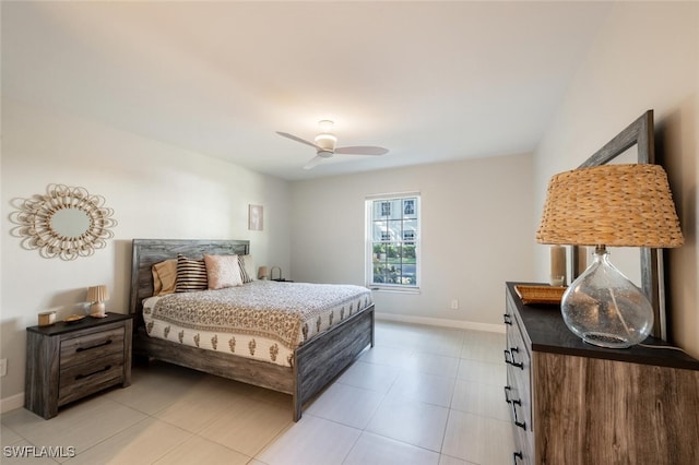 bedroom featuring ceiling fan, baseboards, and light tile patterned flooring