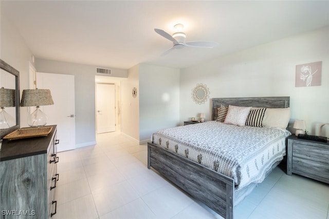 bedroom featuring visible vents, ceiling fan, baseboards, and light tile patterned flooring