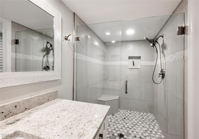 bathroom with a stall shower and vanity