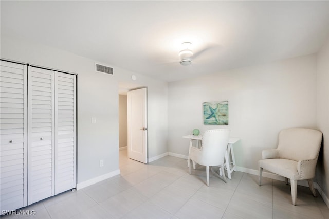 living area with visible vents, baseboards, and light tile patterned flooring