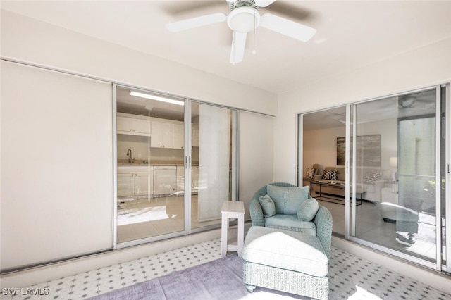 sitting room featuring ceiling fan