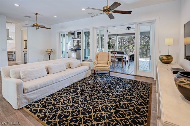 living room featuring ceiling fan and hardwood / wood-style flooring