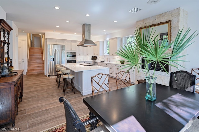 dining area with light hardwood / wood-style floors and sink