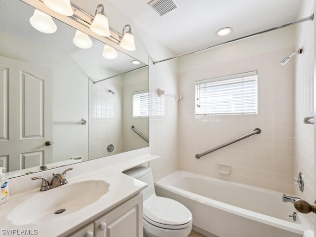 full bathroom featuring toilet, vanity, and tiled shower / bath