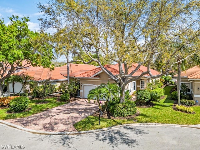 view of front facade with a garage and a front yard