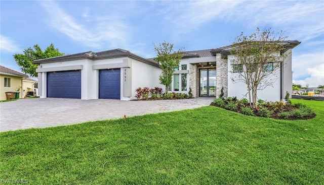 view of front of home featuring a garage and a front lawn