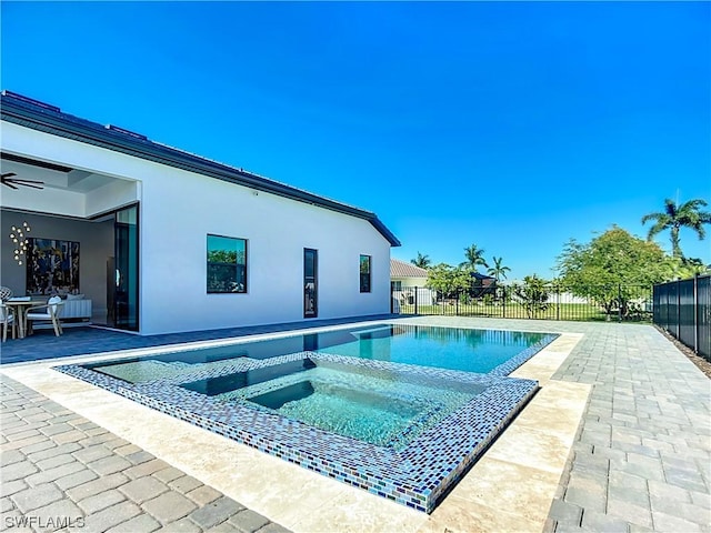 view of pool featuring an in ground hot tub, ceiling fan, and a patio