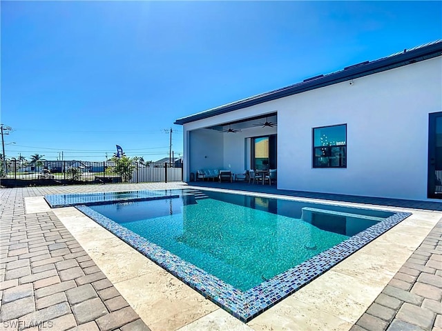 view of pool with ceiling fan and a patio area