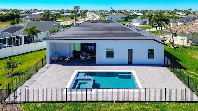 rear view of property with a fenced in pool, a yard, a patio area, and outdoor lounge area