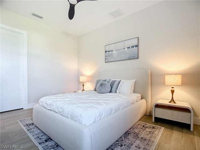 bedroom with hardwood / wood-style flooring and ceiling fan