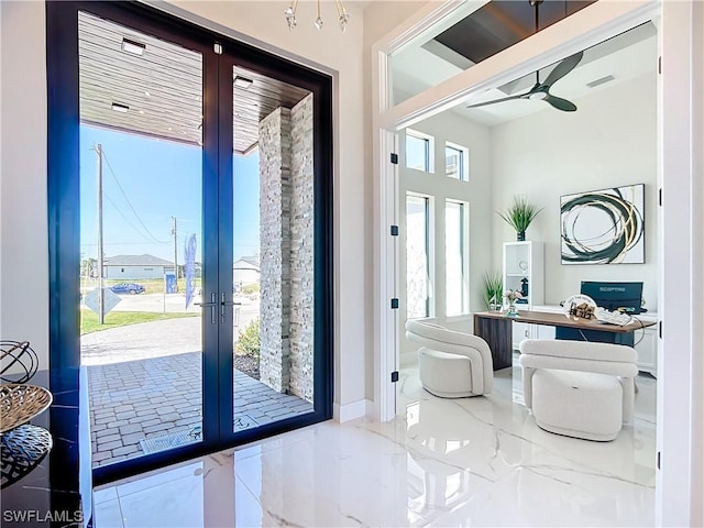 doorway to outside featuring french doors and ceiling fan