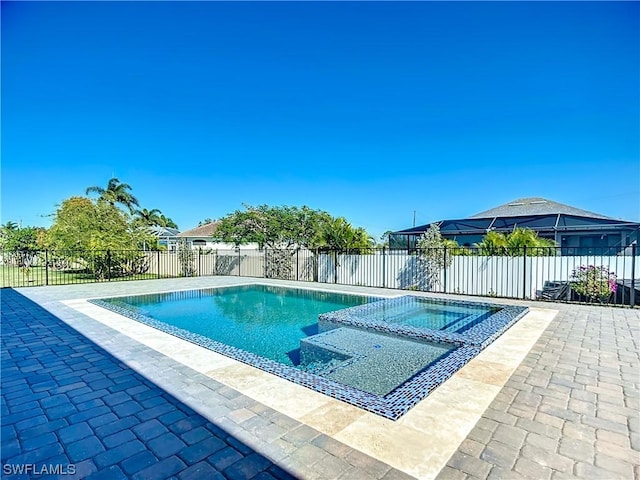 view of pool with a patio and an in ground hot tub