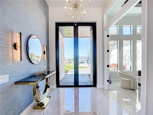 entryway with french doors and a chandelier