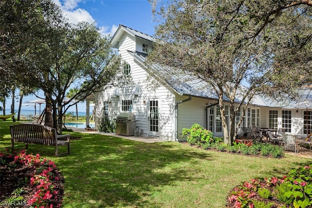 exterior space with a patio area and a lawn