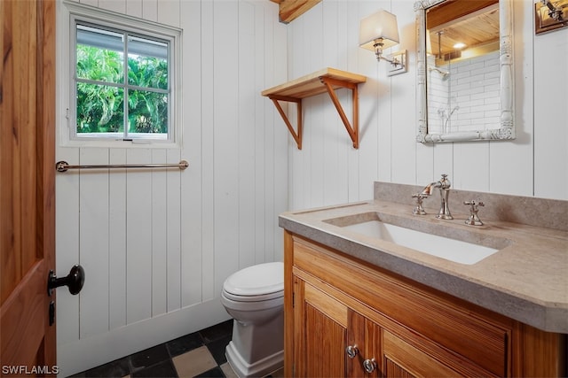 bathroom featuring vanity, tile flooring, and toilet