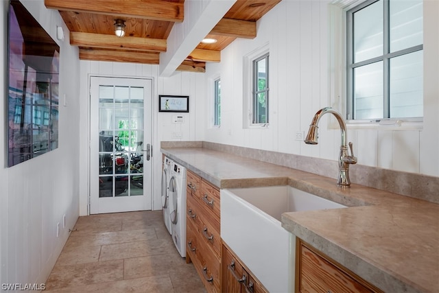 kitchen with a wealth of natural light, beamed ceiling, wood ceiling, and light tile floors