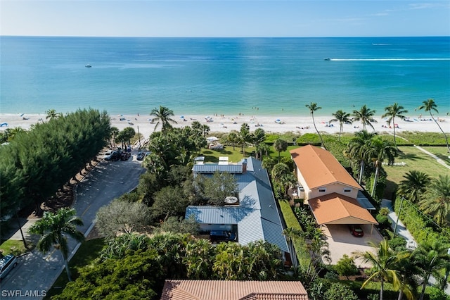 birds eye view of property with a water view and a view of the beach