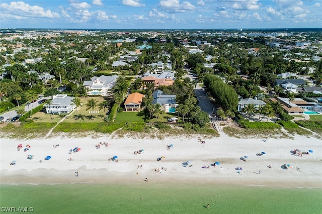 drone / aerial view featuring a water view and a view of the beach