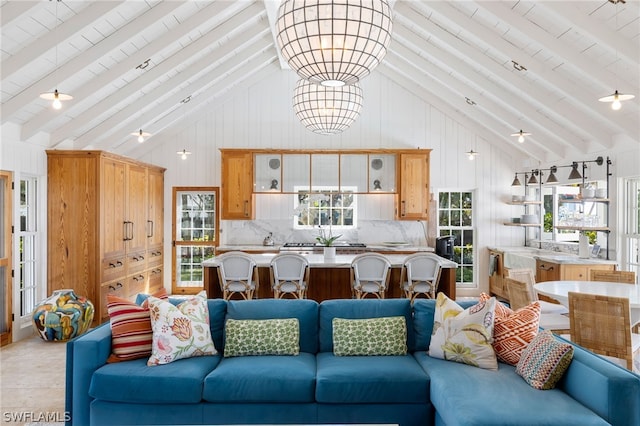 living room featuring high vaulted ceiling and beam ceiling