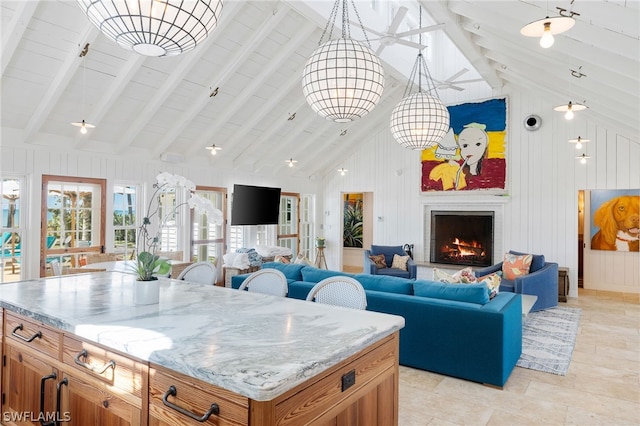 kitchen featuring high vaulted ceiling, a kitchen island, pendant lighting, and beamed ceiling