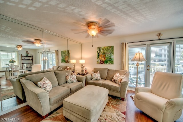 living room featuring wood-type flooring and ceiling fan