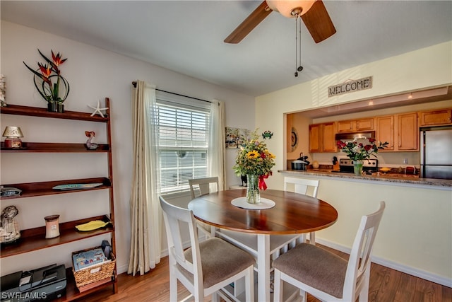 dining room featuring ceiling fan and light wood-type flooring