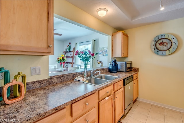 kitchen featuring light tile floors, light brown cabinets, sink, and stainless steel appliances