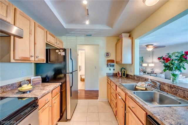 kitchen featuring range, ceiling fan, sink, light tile floors, and a raised ceiling