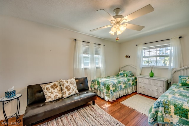 bedroom with ceiling fan and light hardwood / wood-style flooring