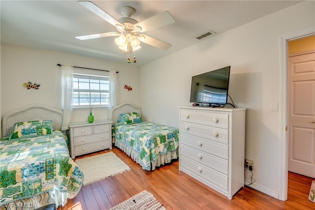 bedroom with ceiling fan and light wood-type flooring