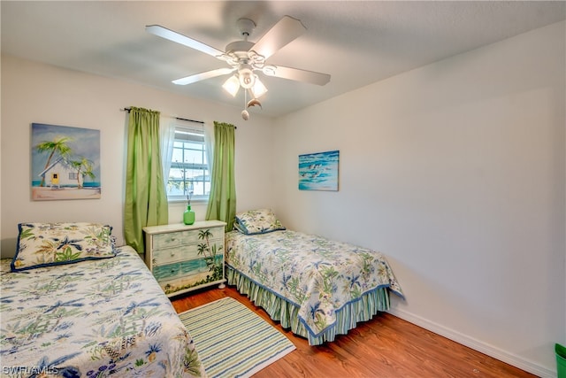 bedroom featuring ceiling fan and dark hardwood / wood-style flooring