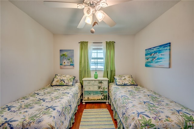 bedroom featuring ceiling fan and dark hardwood / wood-style floors