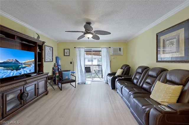 living room with a textured ceiling, ceiling fan, light wood-type flooring, and crown molding