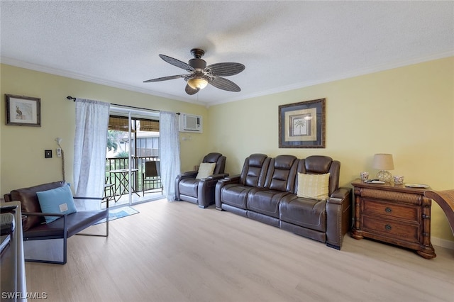 living room with light hardwood / wood-style flooring, ornamental molding, ceiling fan, and a textured ceiling