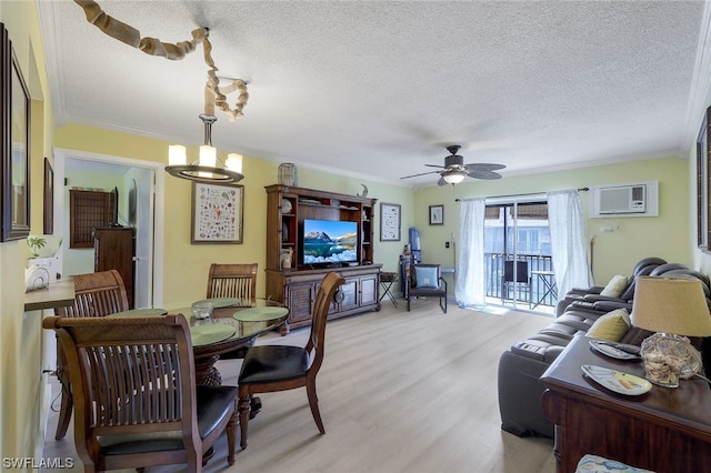 living room featuring crown molding, light hardwood / wood-style flooring, a textured ceiling, and ceiling fan with notable chandelier