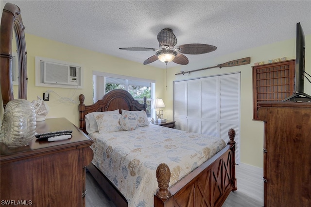 bedroom featuring a closet, a textured ceiling, ceiling fan, and hardwood / wood-style flooring