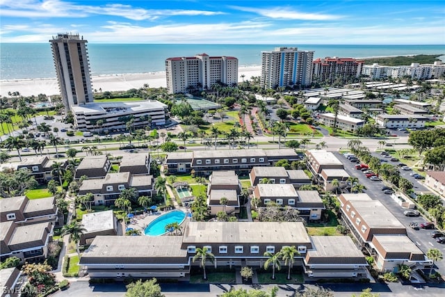 drone / aerial view featuring a beach view and a water view