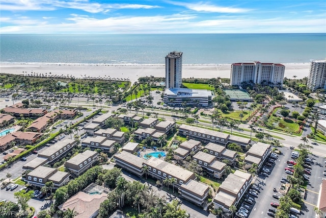 drone / aerial view featuring a beach view and a water view