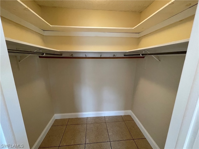 spacious closet with tile patterned floors