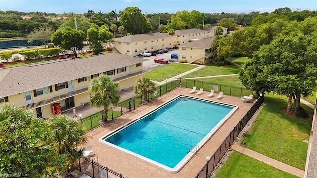 view of pool with a yard