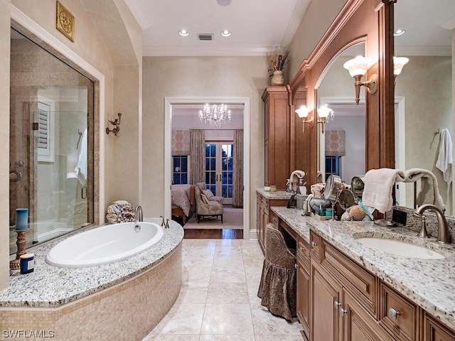 bathroom with a notable chandelier, tile floors, vanity with extensive cabinet space, and ornamental molding