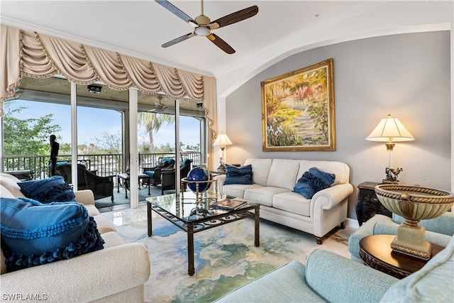 living room with ornamental molding and ceiling fan