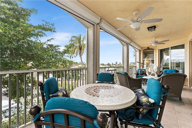 sunroom with ceiling fan and plenty of natural light