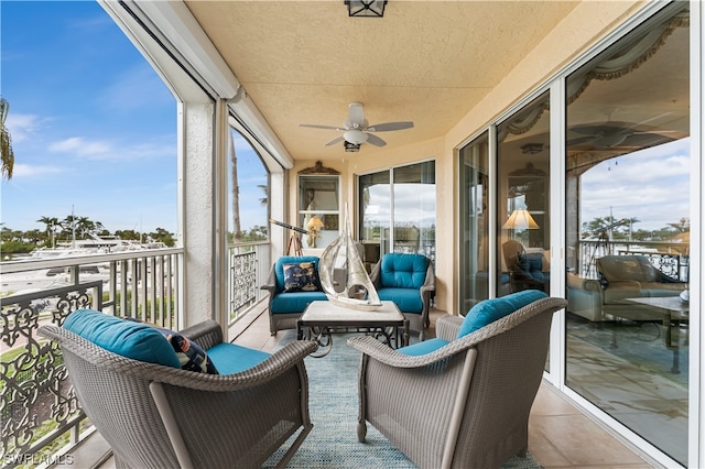 sunroom with a healthy amount of sunlight and ceiling fan